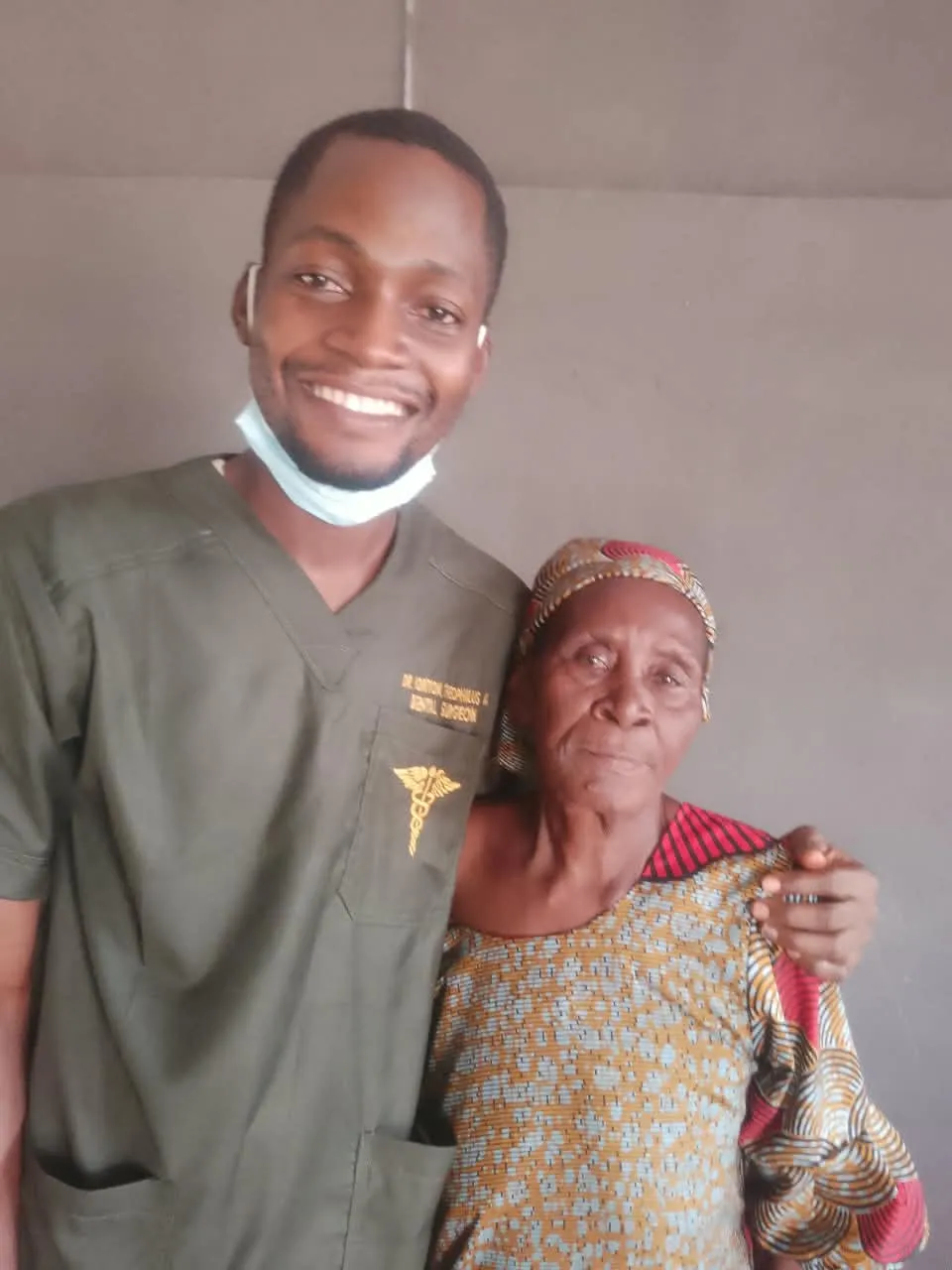 Dr. Iortyom with an elderly patient after her dental visit